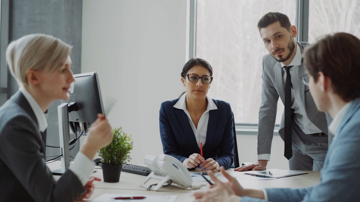 Business professionals collaborating in a modern office meeting.