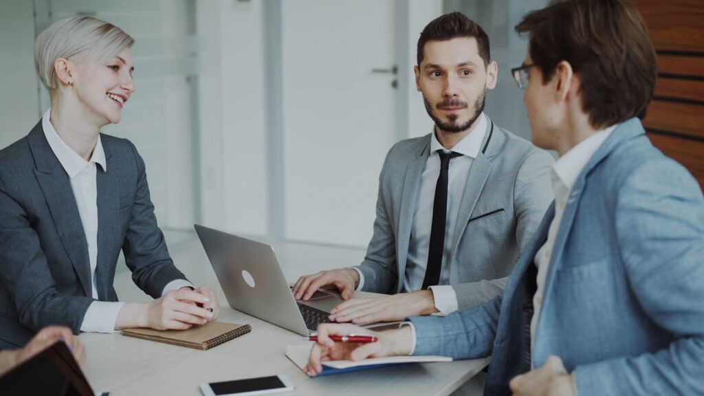 Business professionals in a meeting around a table.
